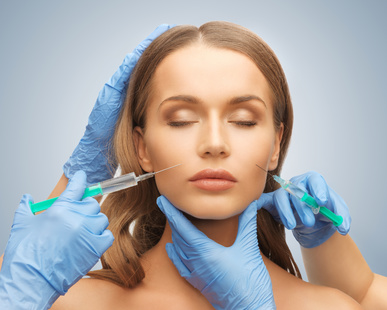 picture of woman face and beautician hands with syringe
